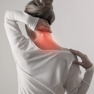 A woman with chronic neck and back pain shown with red highlighting