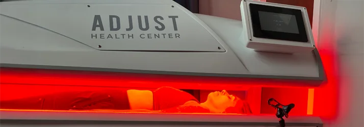 A red light therapy pod with a patient inside receiving treatment