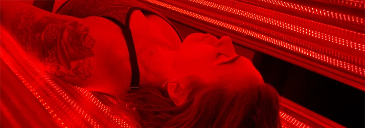 A closeup image of a patient inside a red light therapy pod