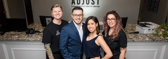 Drs. Jason and Marissa Abaza with their staff standing at the front of their clinic