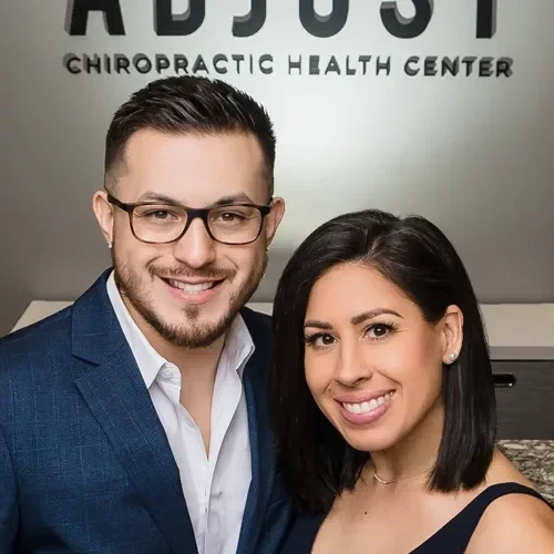 Drs. Jason Abaza and Marissa Abaza posing for a photo in the front of their clinic